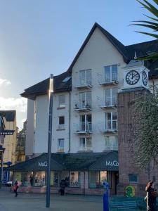 a large building with a clock on the side of it at 1/5 Lismore House in Oban