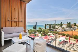 a living room with a view of a beach and the ocean at Hotel Park Plava Laguna in Poreč