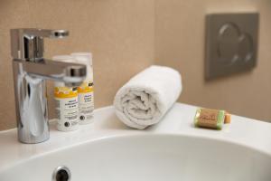 a bathroom with a towel on the edge of a sink at Villa Sokol Apartments Opatija center in Opatija +37 photos