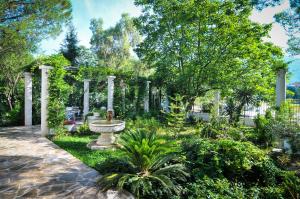 a garden with a fountain in the middle of it at Apartments Villa Stankovic in Tivat