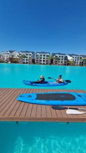 three people in kayaks on a dock in the water at Luxury 264 The Blyde in Pretoria