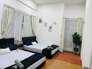 a room with two beds and a couch in it at The Sugar'Barn@D perdana kota bharu in Kota Bharu