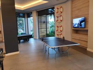 a ping pong table in a living room with a tv at Luxury 264 The Blyde in Pretoria