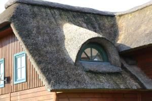 a thatched roof of a house with a window at Chaumière d'Albâtre -Gîte-Détente nature et bien être in Ourville-en-Caux +9 photos