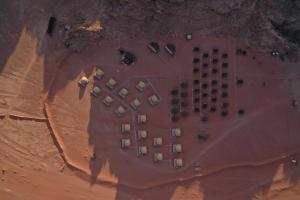an aerial view of a parking lot in the desert at Sun City Camp in Wadi Rum