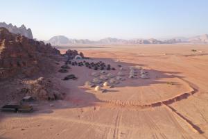 an aerial view of a group of people in the desert at Sun City Camp in Wadi Rum