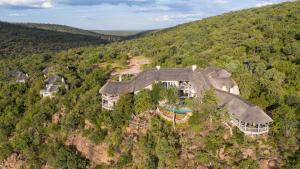 an aerial view of a house on a mountain at Clifftop Exclusive Safari Hideaway in Welgevonden Game Reserve