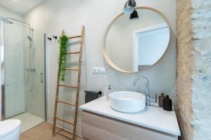 uma casa de banho com um lavatório e um espelho em BeHouse Arroyo A em Sevilha