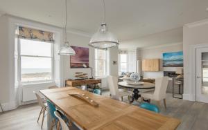 a dining room and living room with a table and chairs at The Beach House in North Berwick