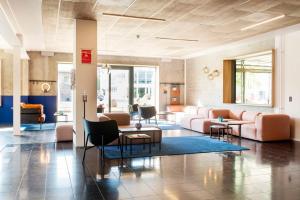 a lobby with couches and chairs and tables at CPH Hotel in Copenhagen