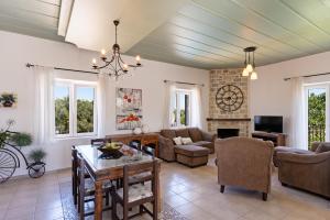 a living room filled with furniture and a fireplace at The Artemis Home, pure rustic romance, By ThinkVilla in Astérion