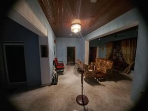 a living room with a couch and a lamp in it at Derick's Inn in Galle
