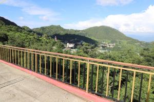 a view of a mountain from a bridge at Riva palace Homestay Rewalsar Lake in Malther