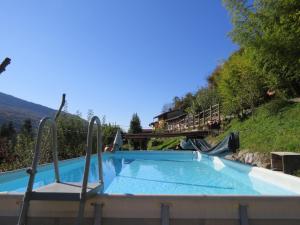 a swimming pool with a slide and a playground at La Nave B&B in Ponte Cremenaga