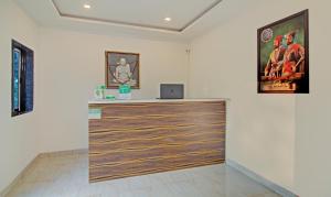 a room with a counter with a laptop on it at Treebo Trend Nakshatra Cottages Mahabaleshwar in Mahabaleshwar