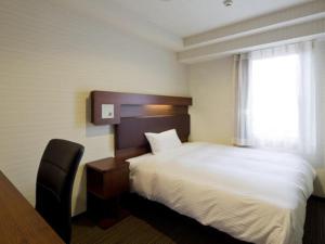 a hotel room with a bed and a window at Green Rich Hotel Kyoto Station South (Artificial hot spring Futamata Yunohana) in Kyoto