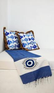 a blue and white blanket with an eye on it at The Blue and White house in Ioulis, Kea in Ioulida