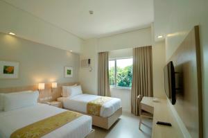 Postel nebo postele na pokoji v ubytování Zerenity Hotel & Suites
