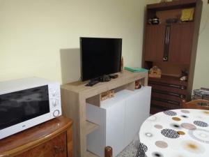 a living room with a tv on top of a counter at GRAZIOSO APPARTAMENTO IN ZONA SANTA RITA in Turin