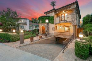 a large house with a patio in the yard at Tuscan Village Villa in San Diego