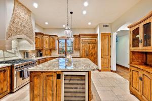 a kitchen with wooden cabinets and a large island at Tuscan Village Villa in San Diego