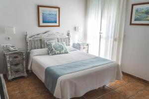 a bedroom with a white bed and white walls at Marissal by Dorobe Hotels in Nerja