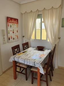 a dining room table with chairs and a window at casa luxury nudista in Vera