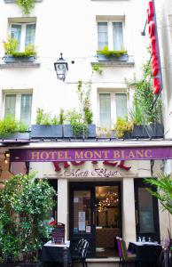 a restaurant with a balcony and a large window at Hôtel du Mont Blanc in Paris