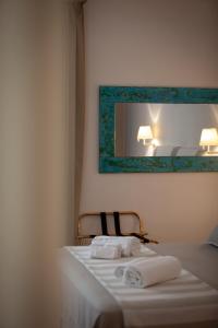 a hotel room with a bed with towels on it at Giardini Calce - Luxury Rooms in Ravello