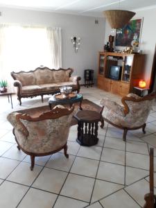 a living room with couches and a tv at Weekend Vikings in Port Shepstone