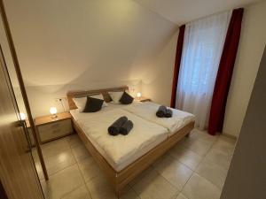 a bedroom with a bed with two shoes on it at 7Schwaben in Bad Urach