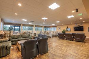 a waiting room with couches and chairs and a flat screen tv at Club Destin Condos in Destin