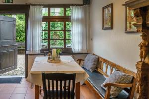 a dining room with a table and chairs and a window at Hotel zur Post Dabringhausen - Quiet Business Hotel near Cologne and Dusseldorf Trade Fairs in Wermelskirchen