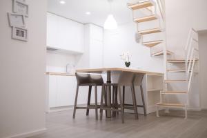 a kitchen with a table and chairs and a staircase at Bed and Breakfast: Nonna Rosa in Bitonto