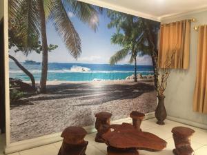 a room with a view of a beach with a window at Losmen PUM Syariah at Desa Wisata Sabang in Sabong