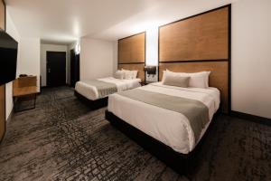 Uma cama ou camas num quarto em AX Hotel