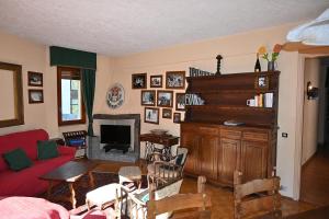 a living room with a couch and a piano at Bardonecchia Appartamento XL in Bardonecchia