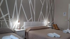 A bed or beds in a room at CconfortHotels R&B Dolci Notti - SELF CHECK IN