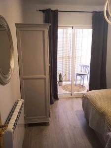 1 dormitorio con puerta que da a una habitación con silla en Hipica Home Granada Center en Granada