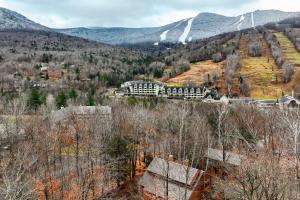 a train is traveling down the tracks in the mountains at Village of Loon Condo in White Mtns with Pool Access in Lincoln