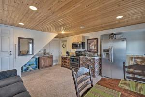 a kitchen with a stainless steel refrigerator and a table at Williston Apartment with Missouri River Views! in Williston