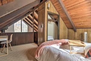 a bedroom with a bed and a table in a room at Fireside Lodge A-Frame in Bryce Resort with Decks in Basye