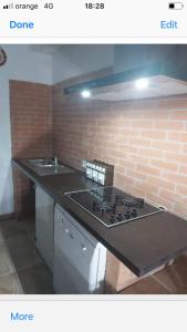 a kitchen with a stove and a brick wall at anastasia 3 in Mediaş