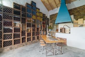 a tasting room with a wall of wine bottles at Casa Fundeira - Quinta dos Esconhais in Castanheira de Pêra