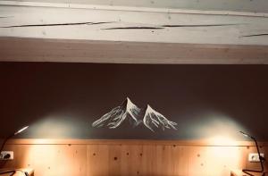 a drawing of a mountain on a wall at Staller Hof in Ruhpolding