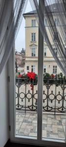 a window with a view of a building at V.I.P.Apartmens Rynok Sqr.19 in Lviv
