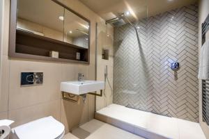 a bathroom with a shower and a toilet and a sink at Twenty Seven HQ in York