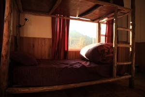 a bunk bed in a room with a window at Odin Hostel Shoja in Shoja