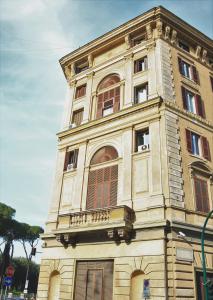 a tall building with windows on top of it at WE LOVE ROMA Guest House in Rome