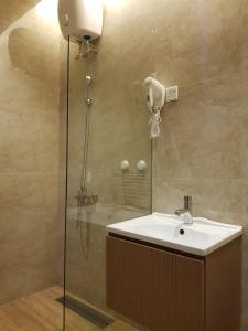 a bathroom with a sink and a shower at Danka@tudor residence in Batam Center +17 photos